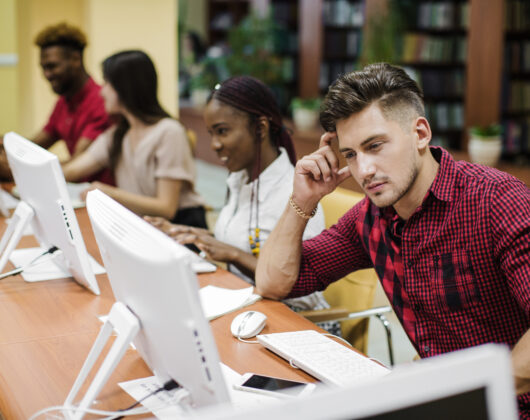 Students learning on macromedia devices in university