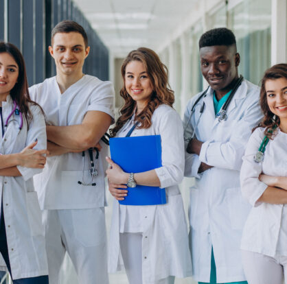 Team of young medical students standing on a hospital corridor