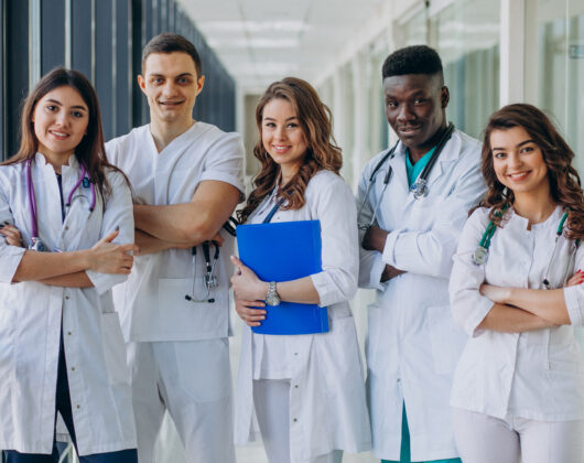 Team of young medical students standing on a hospital corridor