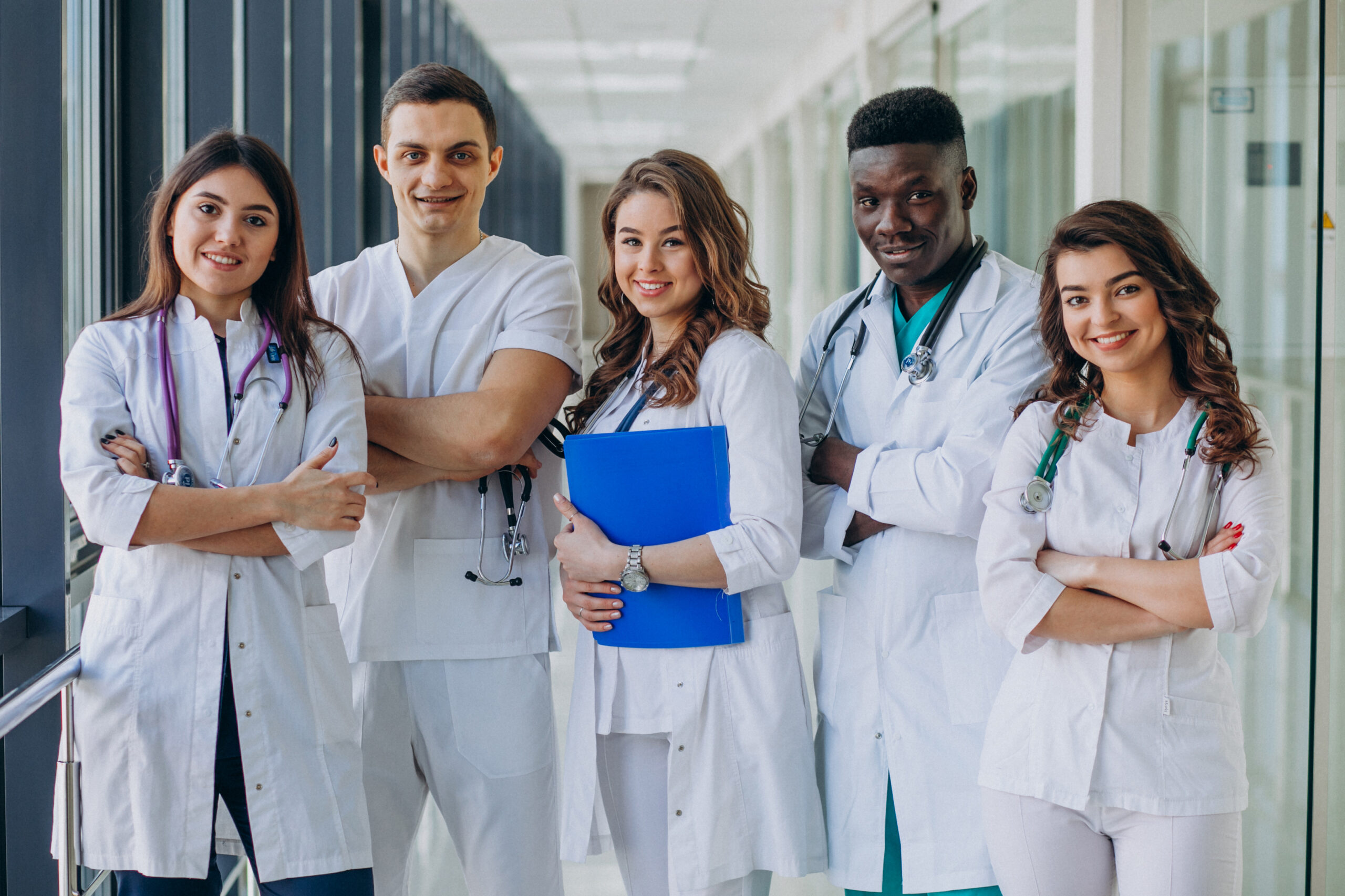 Team of young medical students standing on a hospital corridor