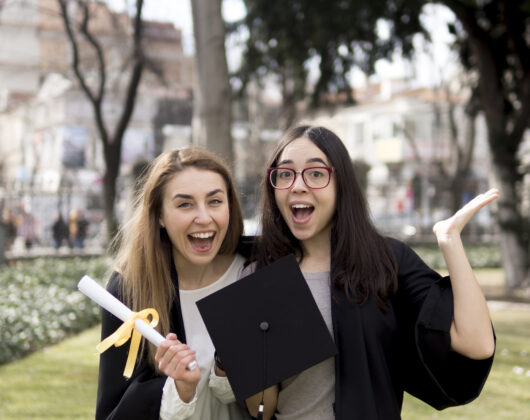 Female students of university feeling happy on their graduation