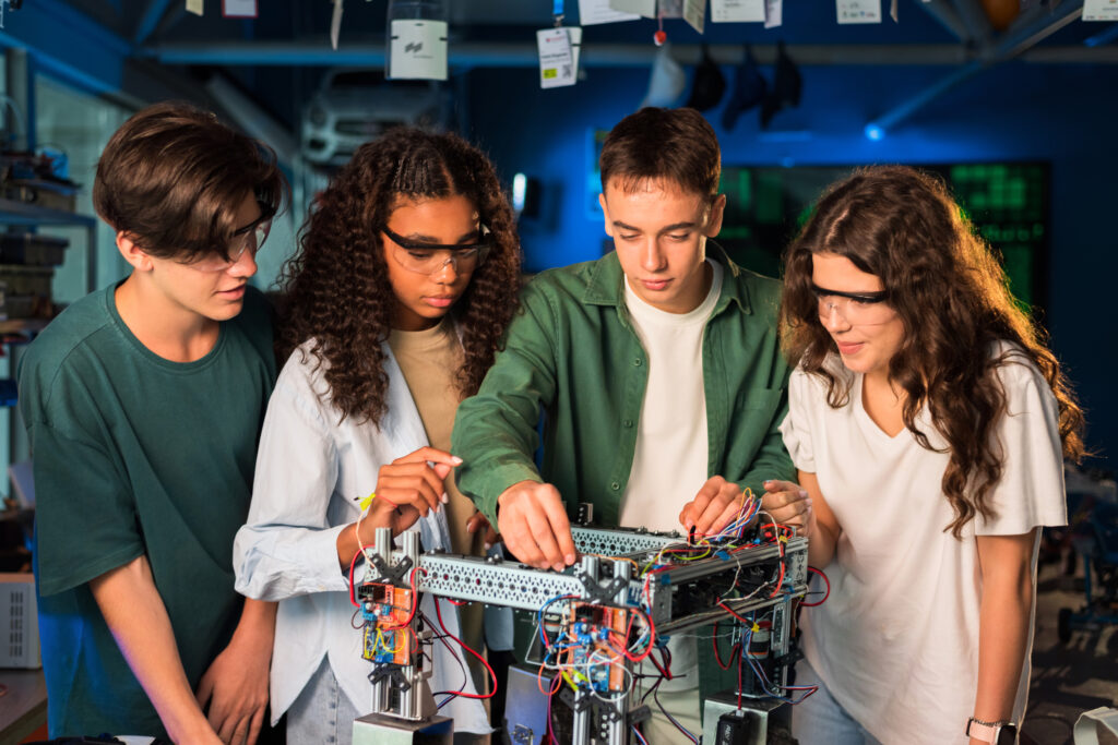 Engineering students wearing protective glasses performing experiment
