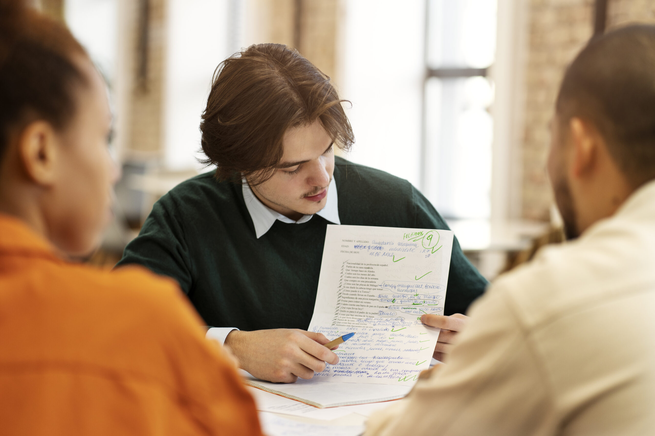 A man writing personal statement with his fellows