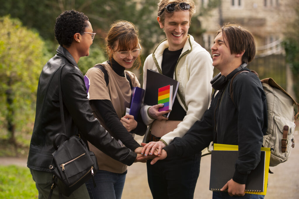 Group students feeling happy wearing bags in front of university