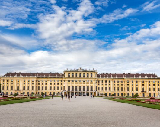 University front view with clouds on sky