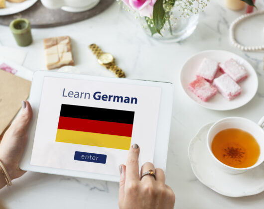 A flag with the call to action for learning german