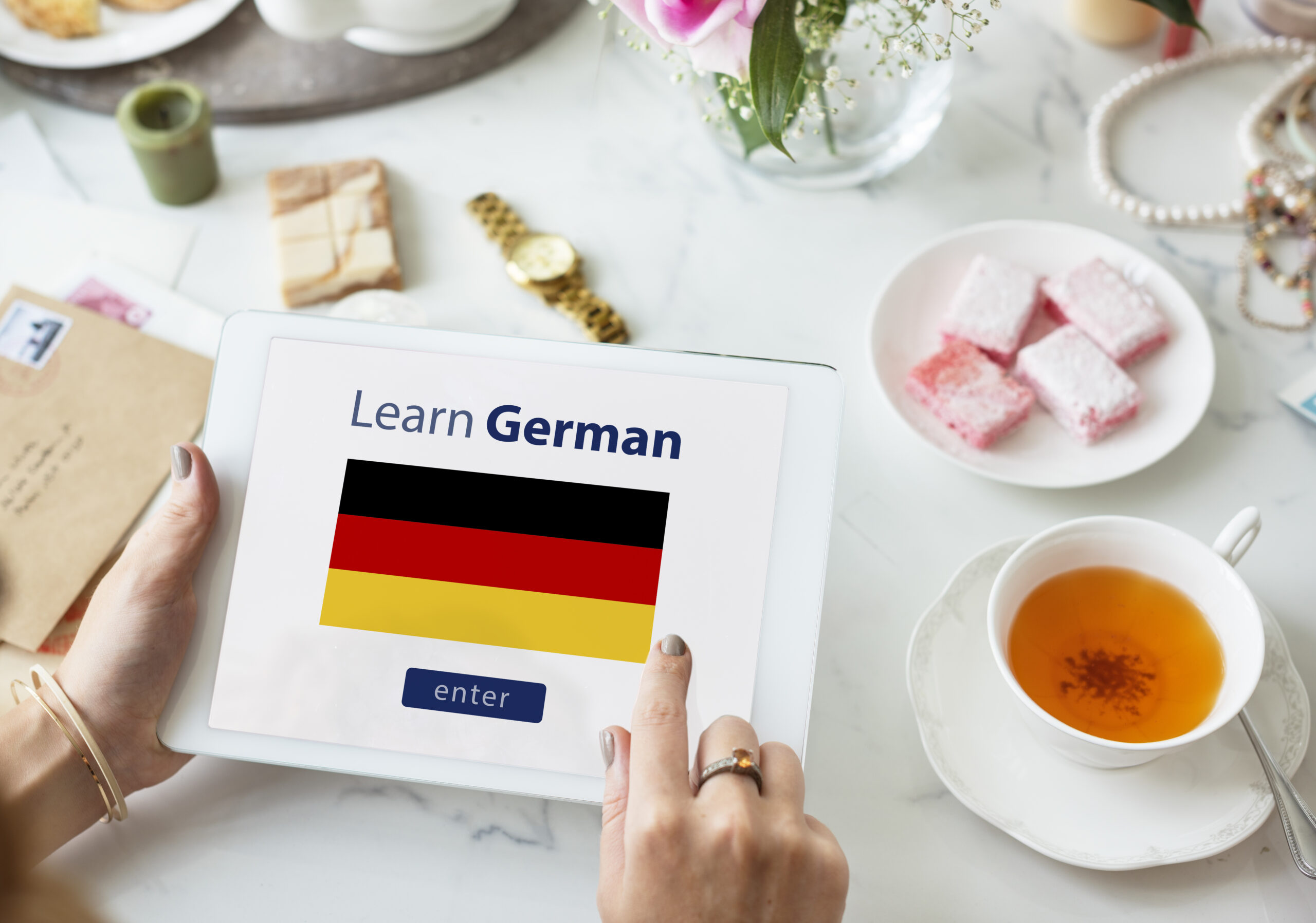 A flag with the call to action for learning german