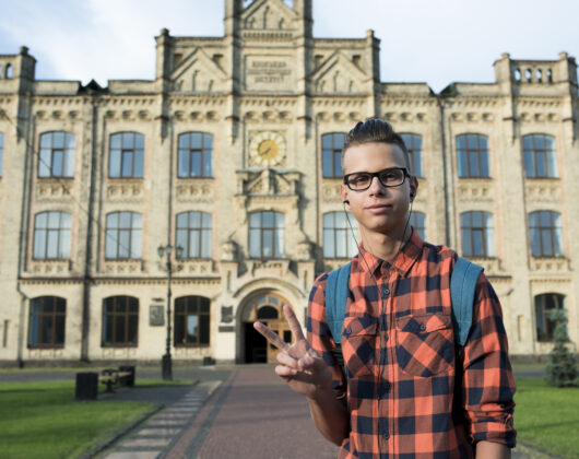 students standing out the university